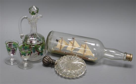 A silver mounted glass flask, a ship in a bottle and a painted claret jug with two glasses etc.